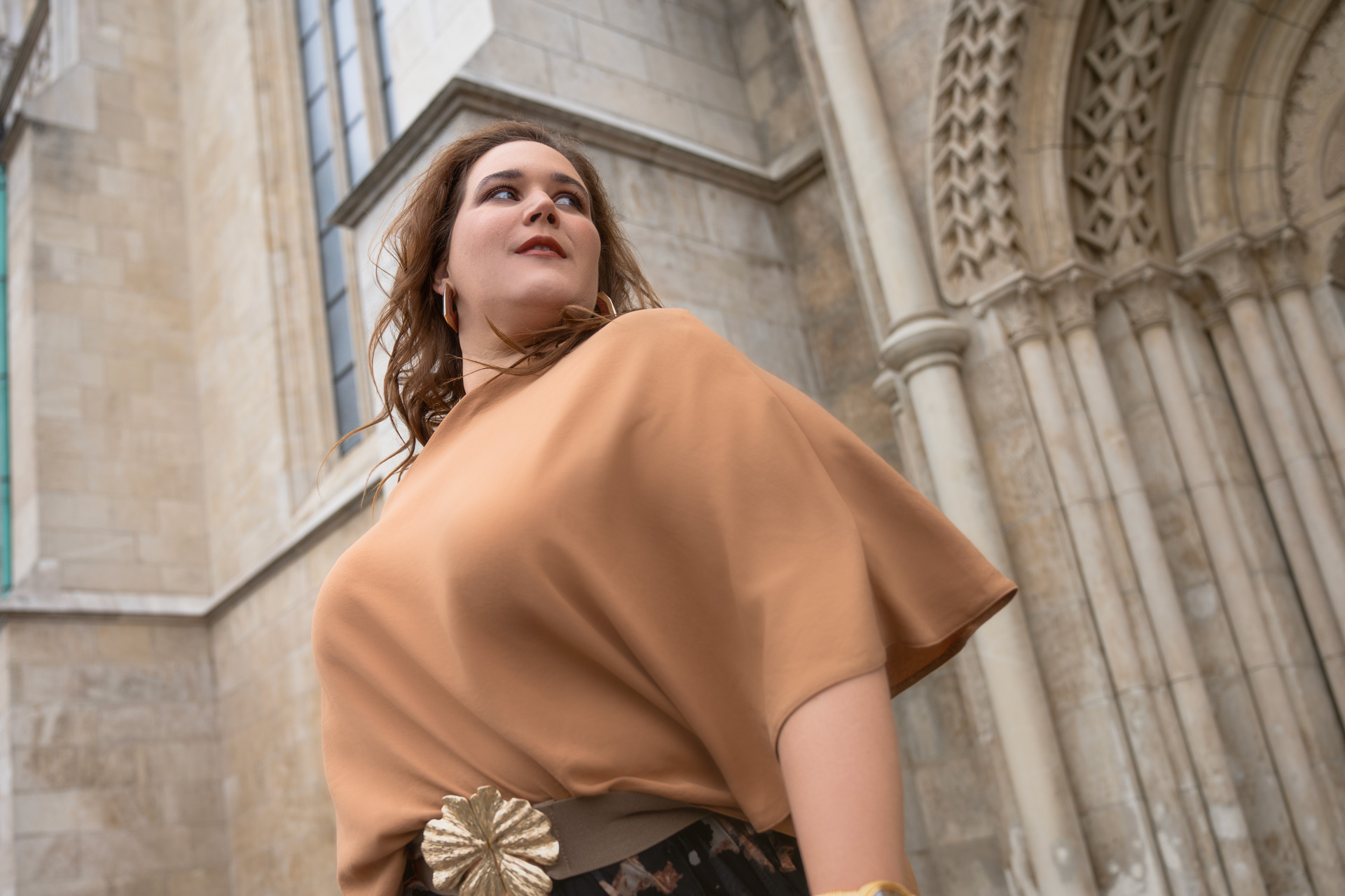 Empowerment portrait of Bernadett Tomasko in a golden dress, photographed at Fisherman’s Bastion in Budapest by Lara’s Media Production.